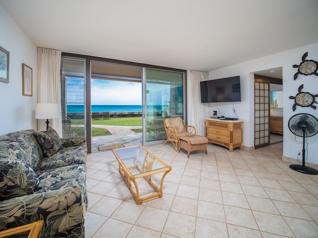 tiled living room featuring a wall of windows