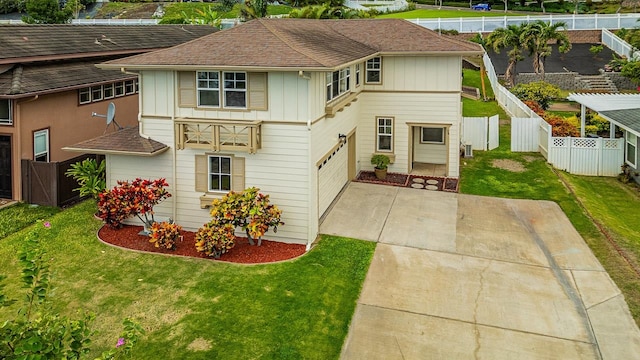 view of front of home with a front yard and a garage