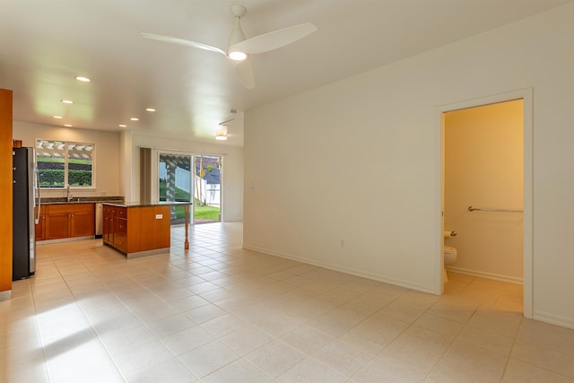 interior space with ceiling fan and sink