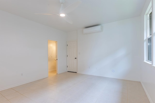 unfurnished room featuring ceiling fan, light tile patterned floors, and a wall unit AC