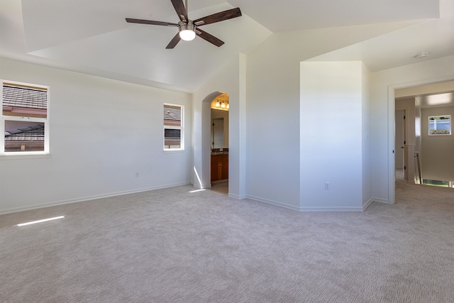 empty room with ceiling fan, light colored carpet, and lofted ceiling