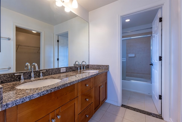 bathroom with tile patterned floors, vanity, and shower / bath combination with glass door