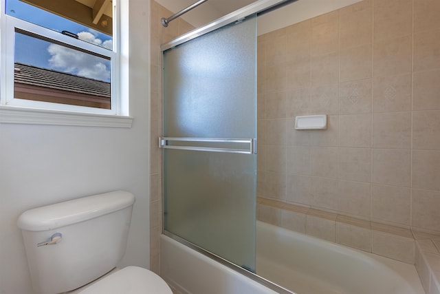 bathroom featuring toilet and enclosed tub / shower combo