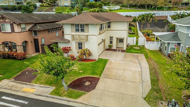 view of front of home featuring a front yard and a garage