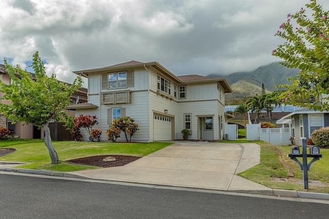 view of front of property featuring a mountain view, a garage, and a front lawn