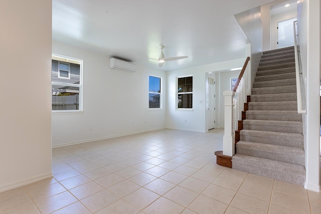 interior space featuring a wall unit AC and ceiling fan