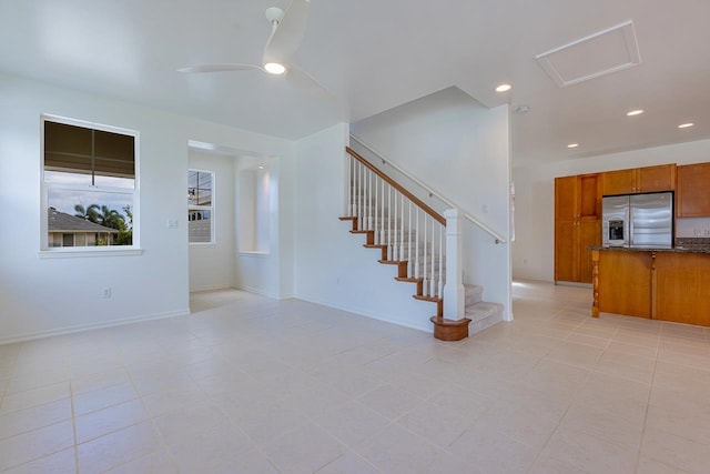 unfurnished living room featuring ceiling fan and light tile patterned flooring