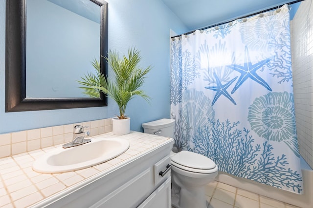 full bathroom with tile patterned flooring, a shower with shower curtain, vanity, and toilet