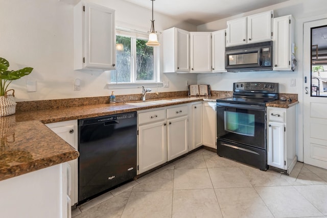 kitchen featuring light tile patterned floors, a sink, white cabinetry, black appliances, and pendant lighting