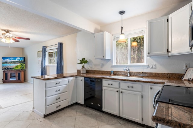 kitchen featuring a peninsula, a sink, plenty of natural light, dishwasher, and dark countertops