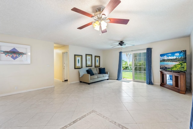 interior space featuring baseboards, a textured ceiling, and light tile patterned flooring