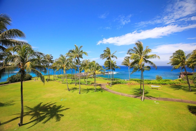 view of home's community with a water view and a yard