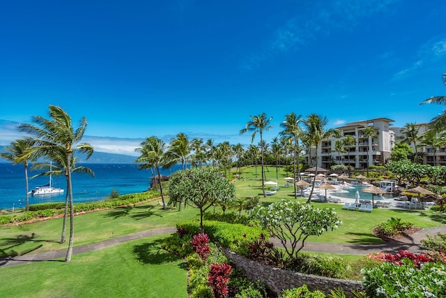 view of property's community featuring a water view and a yard