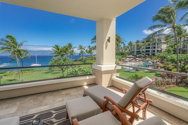 view of patio with a water view and a balcony