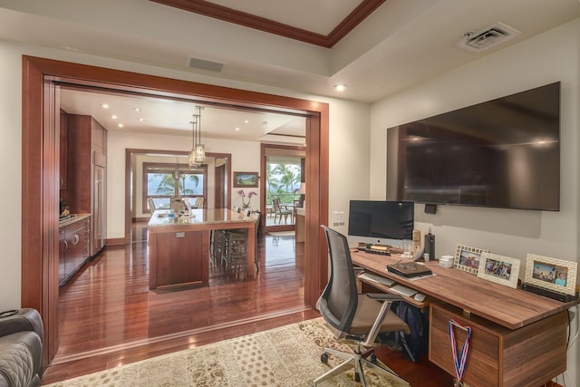 home office with crown molding and dark hardwood / wood-style flooring