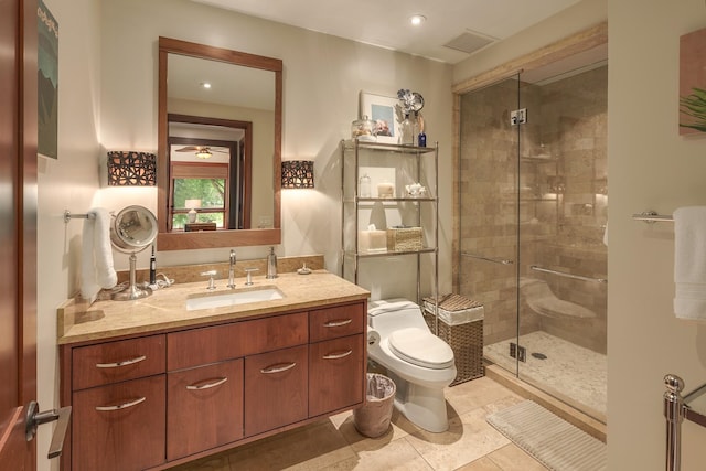 bathroom with vanity, toilet, tile patterned flooring, and a shower with door