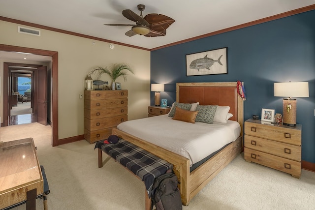 carpeted bedroom featuring crown molding and ceiling fan