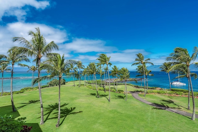 view of home's community featuring a water view and a yard