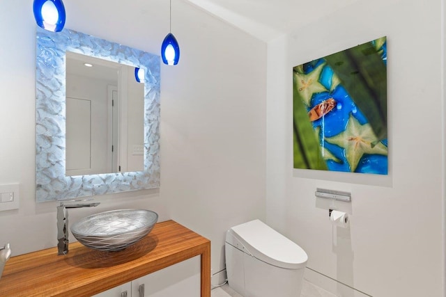 bathroom featuring vanity and toilet