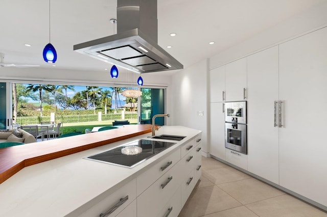 kitchen with white cabinetry, sink, decorative light fixtures, electric cooktop, and island range hood