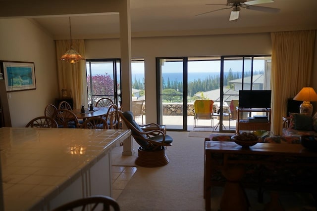 carpeted living room featuring vaulted ceiling and ceiling fan