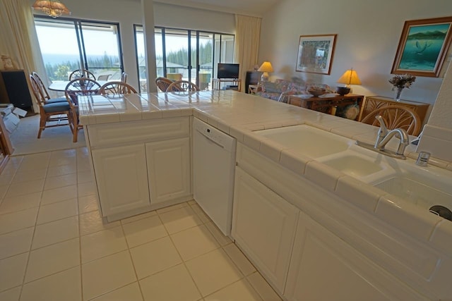 kitchen featuring white cabinetry, tile countertops, light tile floors, and white dishwasher