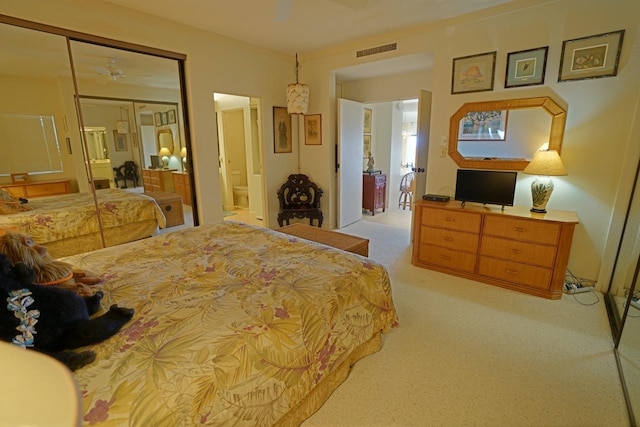 bedroom with a closet and light colored carpet