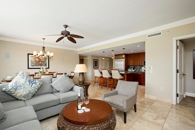 living room featuring ornamental molding and ceiling fan with notable chandelier