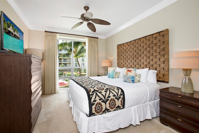 carpeted bedroom with crown molding and ceiling fan