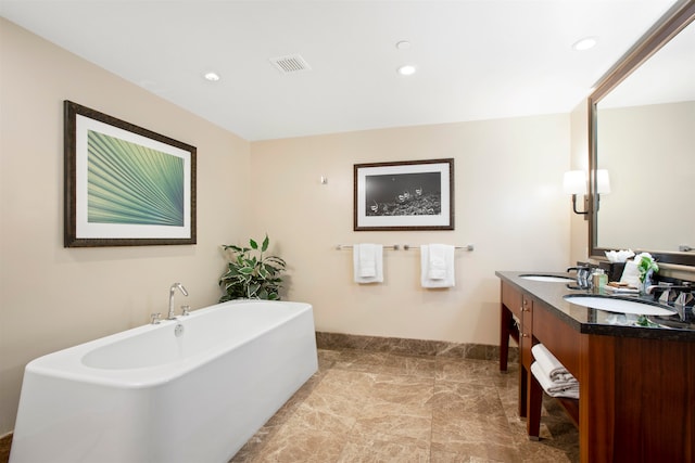 bathroom featuring a bath and vanity