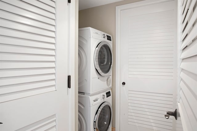 washroom with stacked washer / dryer