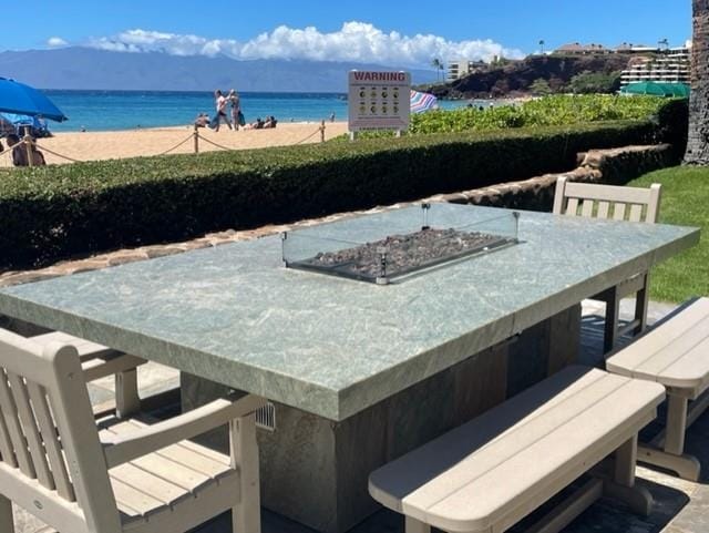 exterior space with an outdoor fire pit and a water view