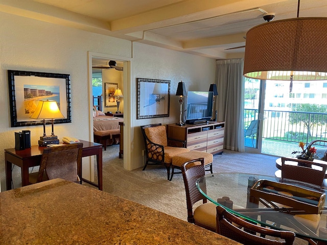 living room featuring beamed ceiling and carpet flooring