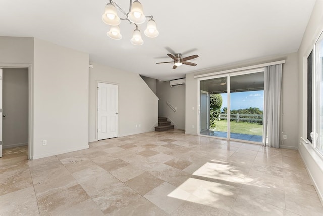 empty room with a wall mounted AC and ceiling fan with notable chandelier