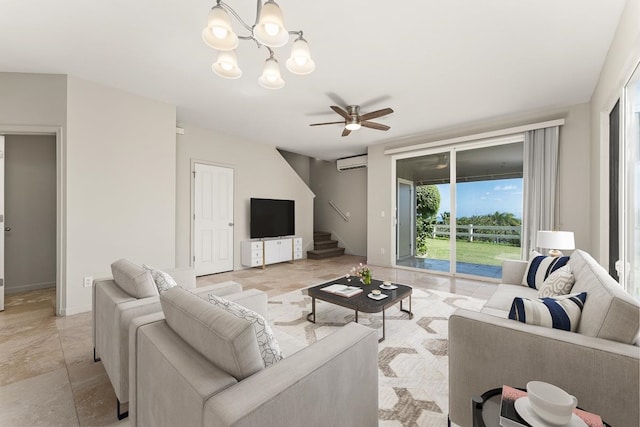 living room featuring a wall unit AC and ceiling fan with notable chandelier