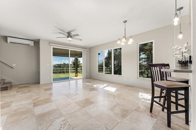 interior space with an AC wall unit and ceiling fan with notable chandelier