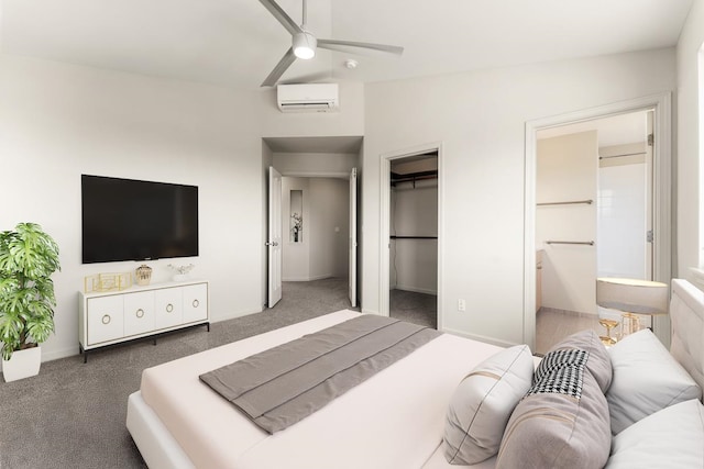 carpeted bedroom featuring ensuite bathroom, a walk in closet, an AC wall unit, ceiling fan, and lofted ceiling