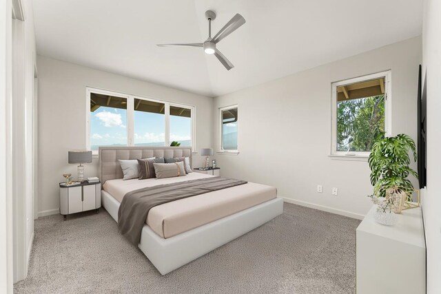 carpeted bedroom with multiple windows and ceiling fan