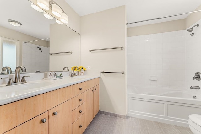 full bathroom with vanity, tiled shower / bath combo, and toilet