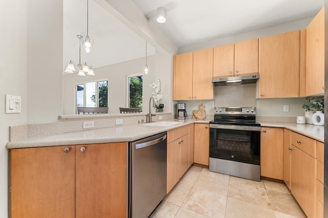 kitchen with stainless steel appliances, sink, light brown cabinets, and an inviting chandelier