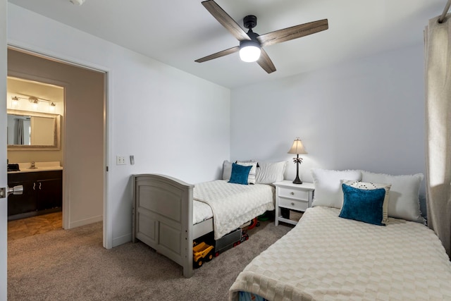 carpeted bedroom featuring ensuite bathroom, ceiling fan, and sink