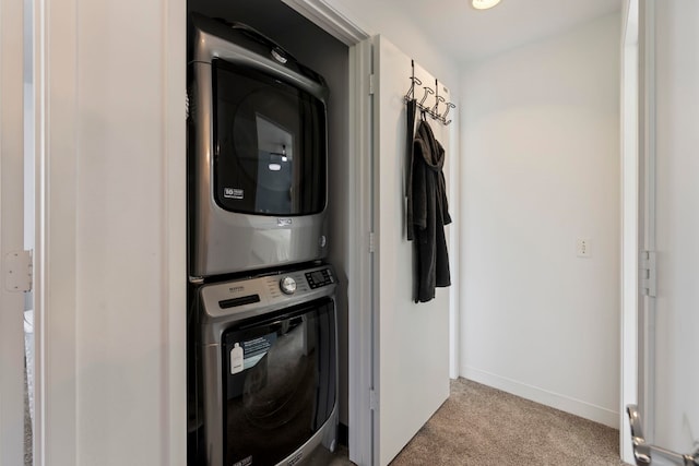 clothes washing area with stacked washer / dryer and light carpet