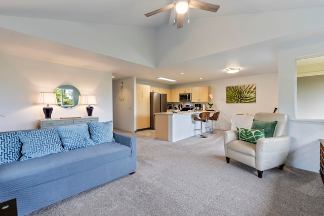 carpeted living room with lofted ceiling and ceiling fan