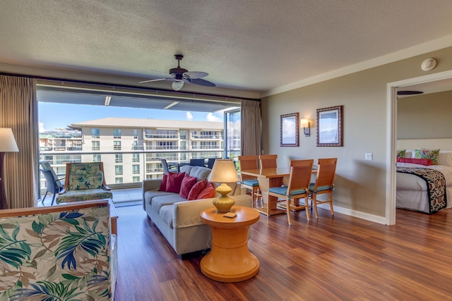 living room featuring a textured ceiling, dark hardwood / wood-style floors, and ceiling fan