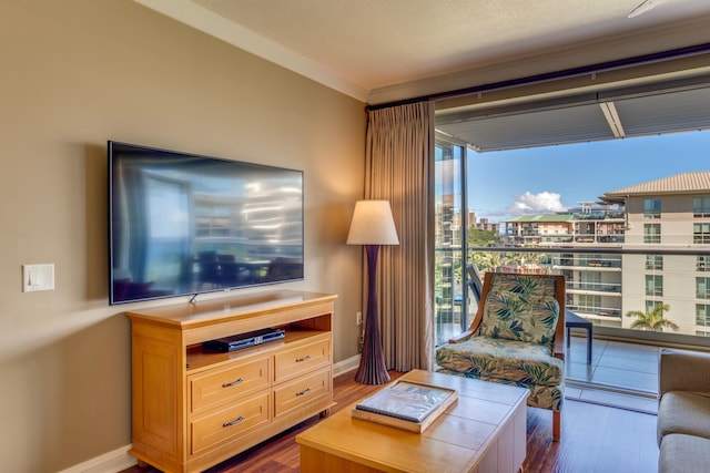 living area with a textured ceiling, hardwood / wood-style flooring, and floor to ceiling windows