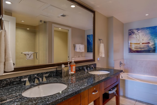 bathroom with vanity, tile patterned flooring, and plus walk in shower