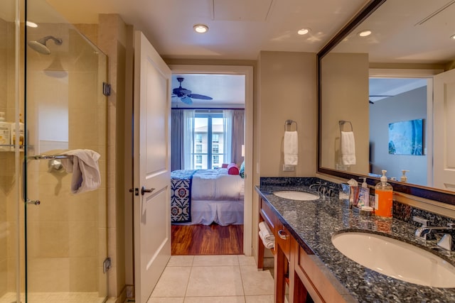 bathroom with vanity, ceiling fan, tile patterned floors, and a shower with shower door