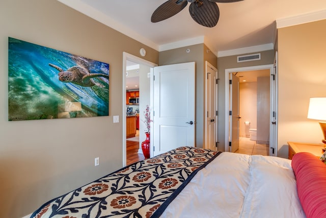 bedroom featuring ensuite bath, crown molding, light wood-type flooring, and ceiling fan