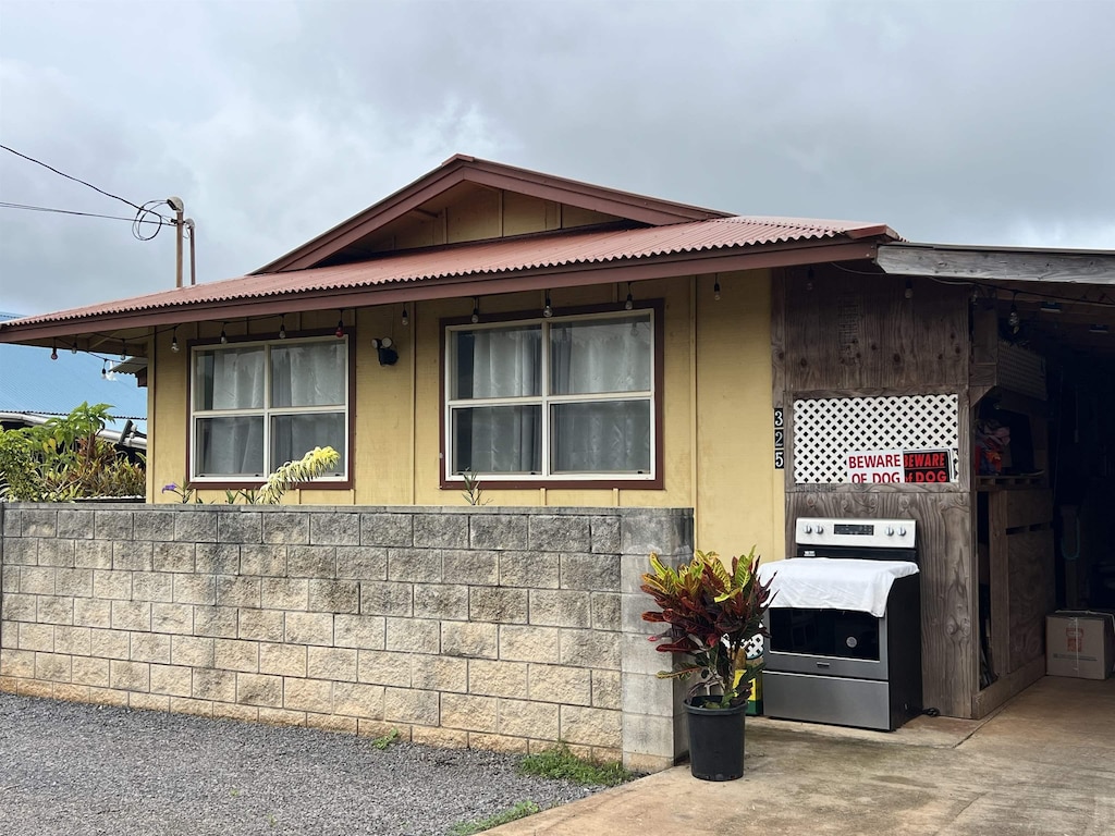 view of side of home with metal roof