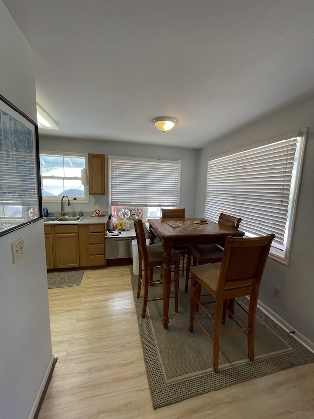 dining room with light wood-style flooring and baseboards